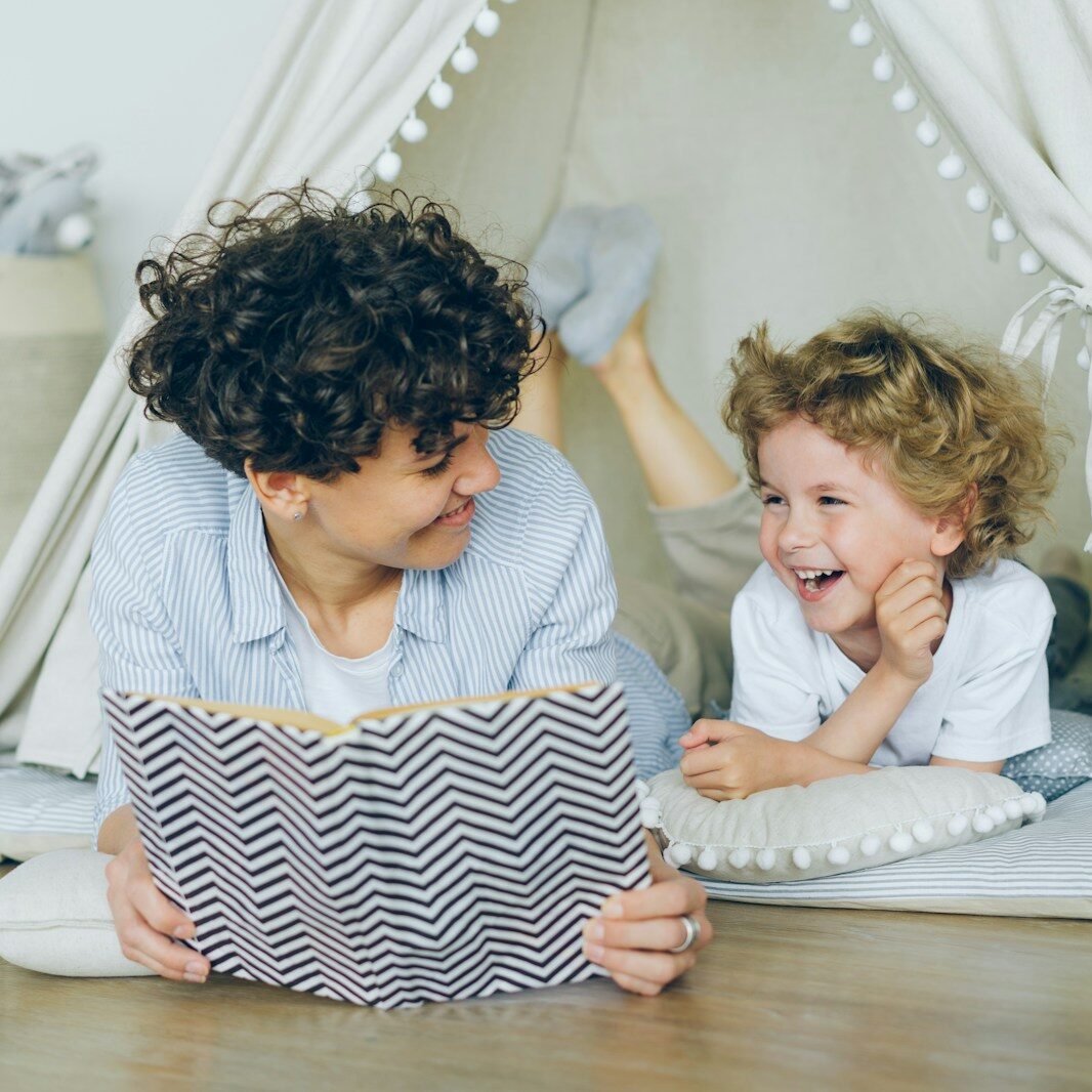 a woman reading a book to a child